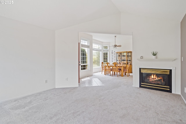 1939 NE Harewood Pl, Hillsboro, OR 97124 - carpeted living area with a glass covered fireplace, ceiling fan, and high vaulted ceiling