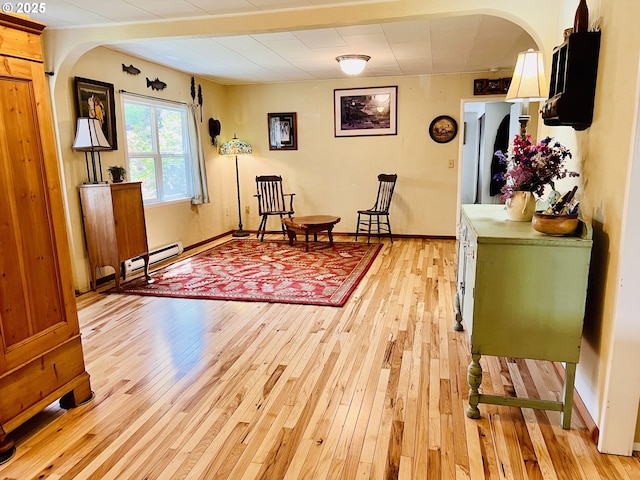 42799 Leaburg Dr, Walterville, OR 97489 - sitting room featuring arched walkways, baseboards, baseboard heating, and light wood finished floors