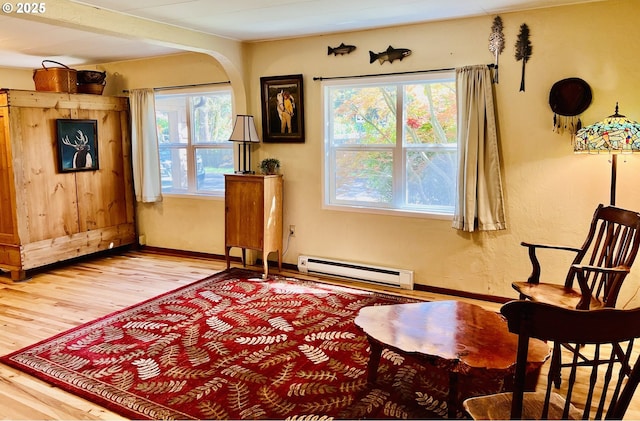 42799 Leaburg Dr, Walterville, OR 97489 - sitting room featuring arched walkways, baseboards, baseboard heating, and wood finished floors