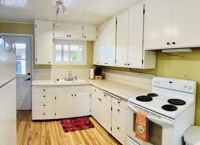 42799 Leaburg Dr, Walterville, OR 97489 - kitchen featuring light wood-type flooring, a sink, light countertops, white appliances, and white cabinetry