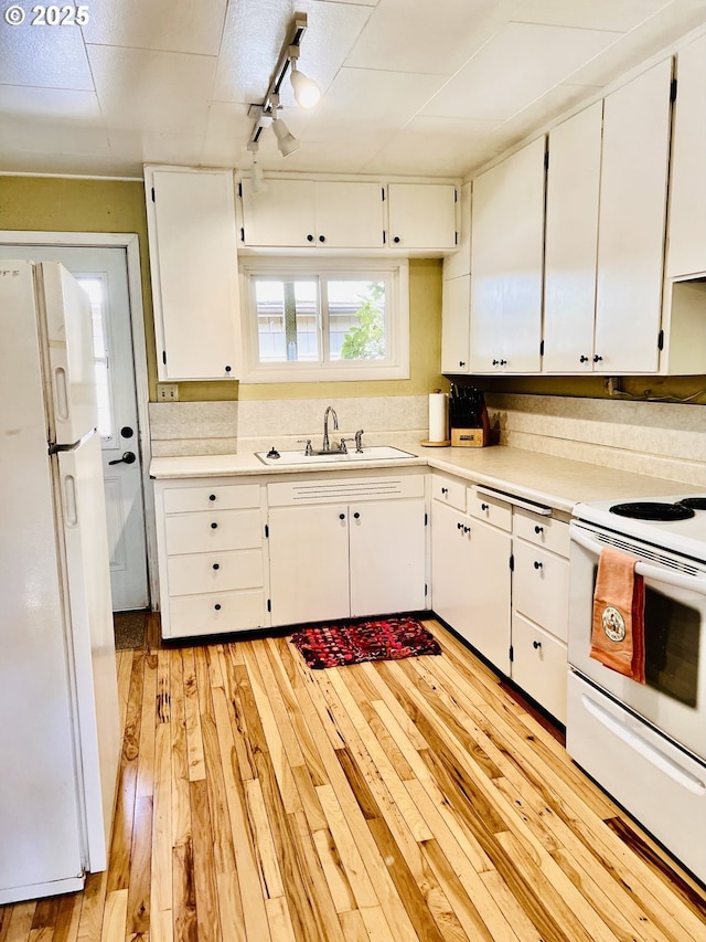 42799 Leaburg Dr, Walterville, OR 97489 - kitchen with a sink, light wood-style flooring, white appliances, and light countertops