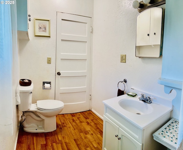 42799 Leaburg Dr, Walterville, OR 97489 - half bath featuring vanity, wood finished floors, and toilet