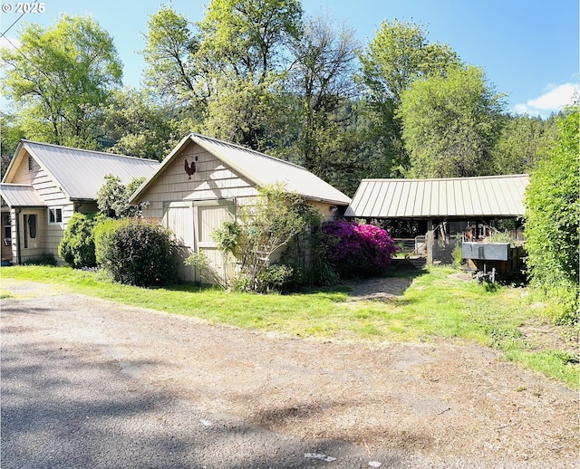 42799 Leaburg Dr, Walterville, OR 97489 - view of property exterior featuring a detached carport and metal roof