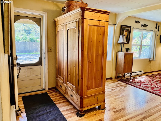 42799 Leaburg Dr, Walterville, OR 97489 - interior space featuring light wood-type flooring, arched walkways, and baseboard heating