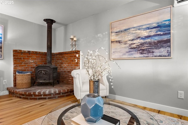 2450 Eddy Ave NE, Salem, OR 97301 - living area featuring a wood stove, wood finished floors, and baseboards