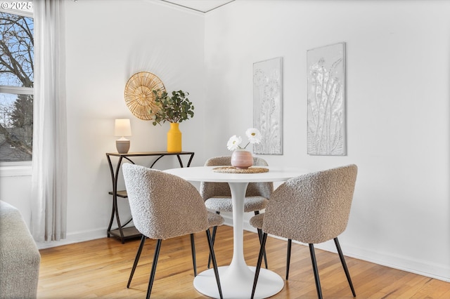 dining area featuring wood finished floors and baseboards