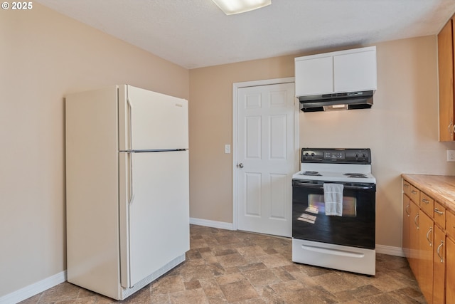 4656 Ocean Beach Hwy, Longview, WA 98632 - kitchen with freestanding refrigerator, electric range oven, under cabinet range hood, stone finish floors, and white cabinetry