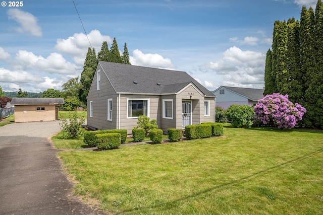 4656 Ocean Beach Hwy, Longview, WA 98632 - bungalow featuring roof with shingles, a front yard, and asphalt driveway