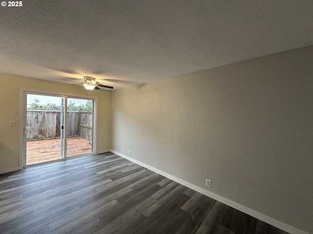 unfurnished room with dark wood-style flooring, ceiling fan, a textured ceiling, and baseboards