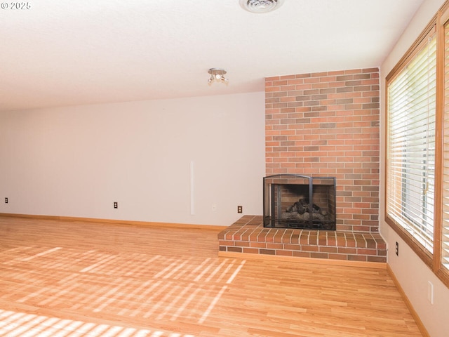 unfurnished living room with light hardwood / wood-style floors and a fireplace