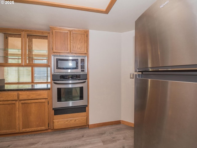 kitchen with stainless steel appliances and light hardwood / wood-style floors