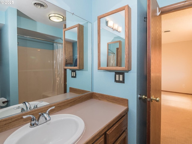 bathroom with a shower with curtain and vanity