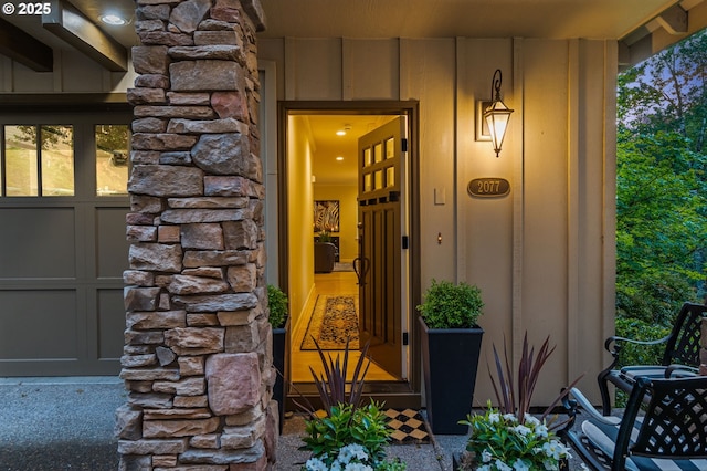 property entrance featuring stone siding and board and batten siding