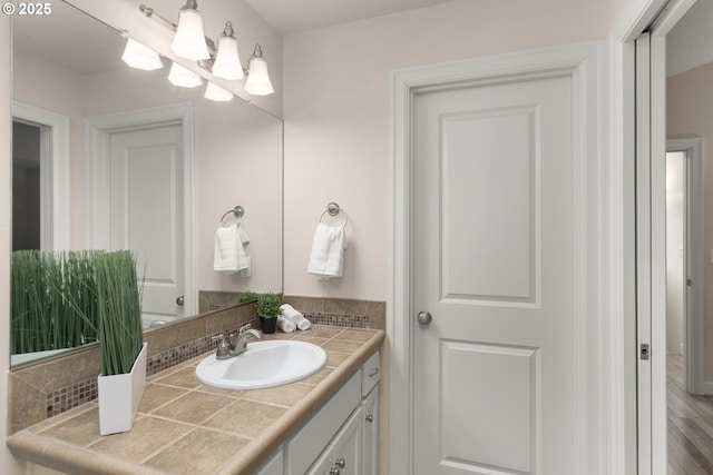 bathroom with a chandelier and vanity