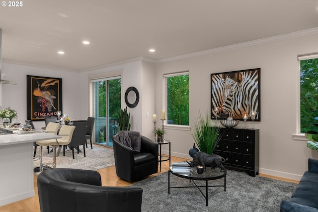 living area featuring plenty of natural light, wood finished floors, ornamental molding, recessed lighting, and baseboards
