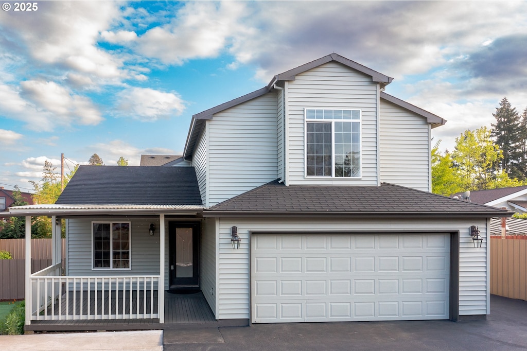 7220 SE Ogden St, Portland, OR 97206 - traditional-style house featuring a garage, aphalt driveway, fence, and covered porch