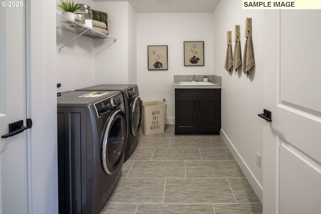 1403 N 41st Pl, Ridgefield, WA 98642 - laundry room featuring washing machine and dryer, wet bar, baseboards, and cabinet space