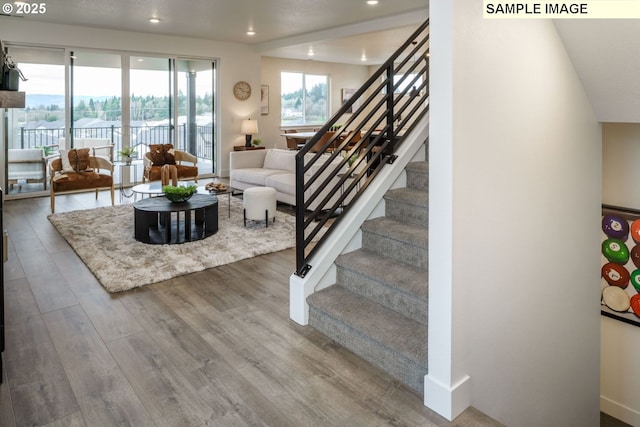 1403 N 41st Pl, Ridgefield, WA 98642 - living room with stairs, wood finished floors, recessed lighting, and baseboards