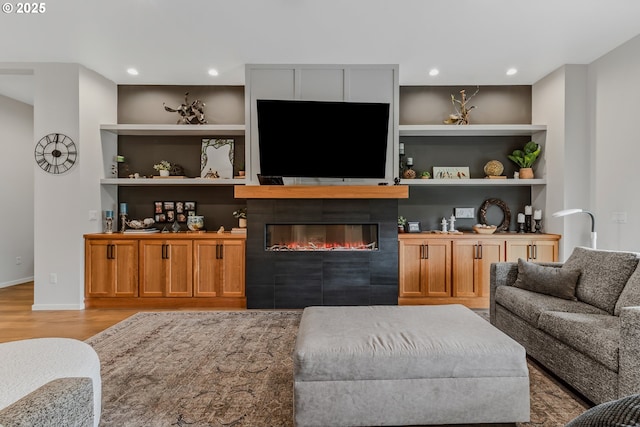 18500 NE 79th St, Vancouver, WA 98682 - living room with light wood-type flooring, a glass covered fireplace, built in shelves, and recessed lighting