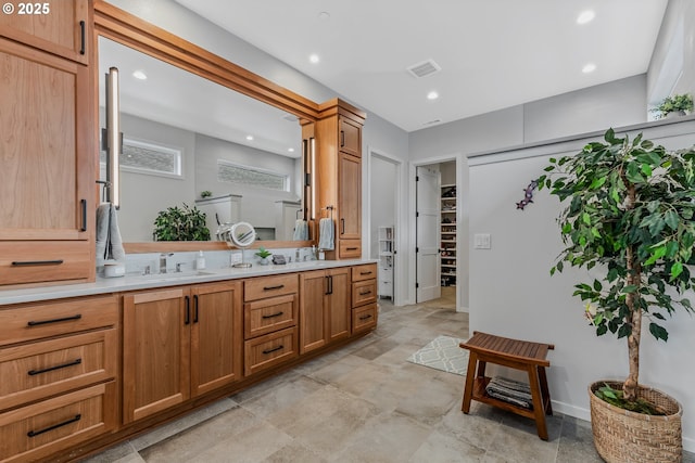 18500 NE 79th St, Vancouver, WA 98682 - bathroom with double vanity, stone finish floors, recessed lighting, and a walk in closet