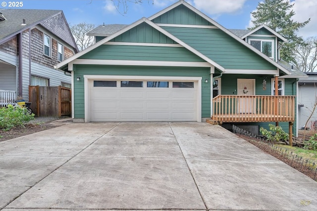 view of front facade featuring covered porch, concrete driveway, an attached garage, board and batten siding, and fence