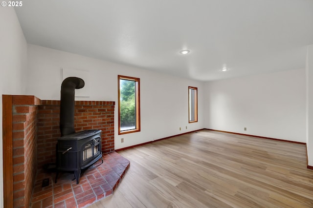 915 Marquet Way, Eugene, OR 97401 - unfurnished living room with a wood stove, baseboards, light wood-style flooring, and recessed lighting