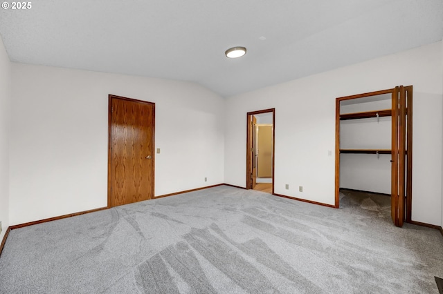 915 Marquet Way, Eugene, OR 97401 - unfurnished bedroom featuring baseboards, carpet, lofted ceiling, and a walk in closet