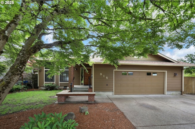915 Marquet Way, Eugene, OR 97401 - obstructed view of property with concrete driveway, an attached garage, and a shingled roof