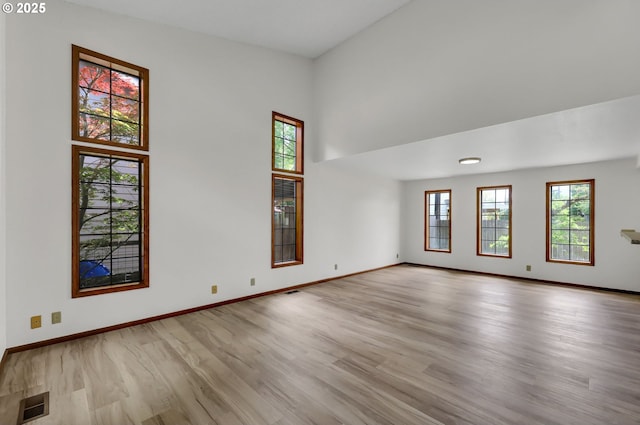 915 Marquet Way, Eugene, OR 97401 - empty room with wood finished floors, a towering ceiling, and baseboards