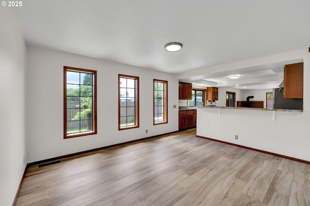915 Marquet Way, Eugene, OR 97401 - unfurnished living room featuring light wood-style floors and baseboards