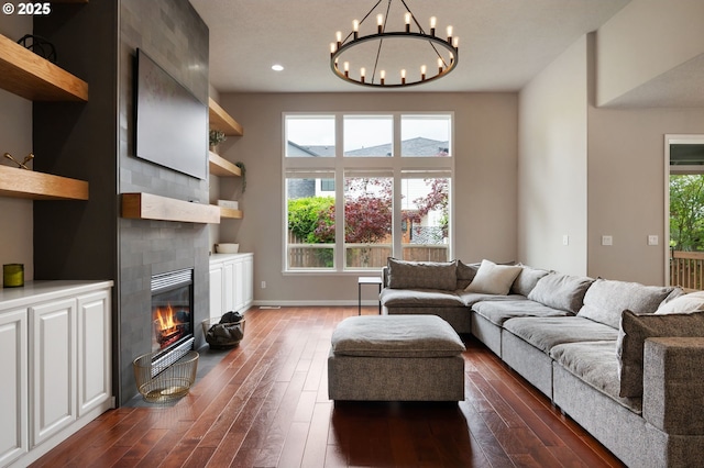 14925 SE Pebble Beach Dr, Happy Valley, OR 97086 - living area with dark wood-type flooring, a chandelier, a fireplace, recessed lighting, and baseboards
