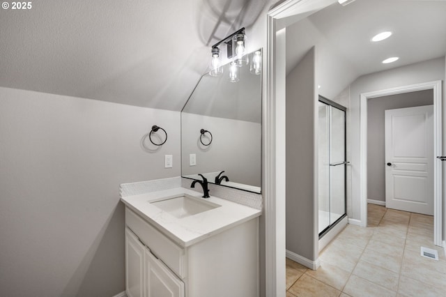 14925 SE Pebble Beach Dr, Happy Valley, OR 97086 - bathroom with vanity, lofted ceiling, a shower stall, tile patterned flooring, and baseboards