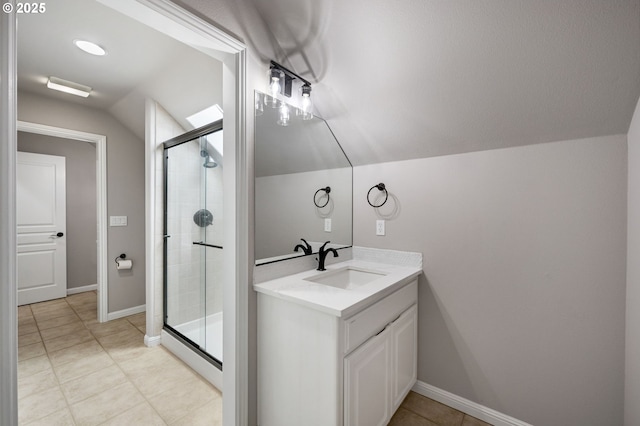 14925 SE Pebble Beach Dr, Happy Valley, OR 97086 - bathroom with vaulted ceiling, a stall shower, vanity, baseboards, and tile patterned floors
