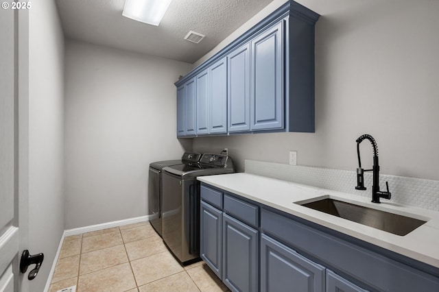 14925 SE Pebble Beach Dr, Happy Valley, OR 97086 - washroom with cabinet space, independent washer and dryer, light tile patterned floors, a textured ceiling, and baseboards