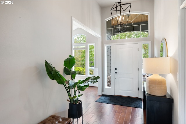 14925 SE Pebble Beach Dr, Happy Valley, OR 97086 - entrance foyer featuring wood finished floors, a chandelier, and a high ceiling