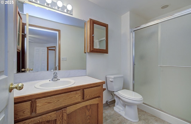 full bathroom featuring a shower stall, toilet, and vanity