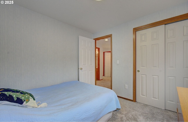 bedroom featuring a closet and light colored carpet