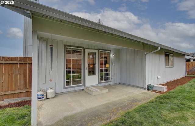 entrance to property with a patio area and fence