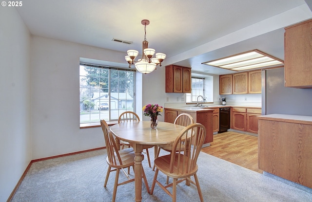 dining area with light colored carpet, an inviting chandelier, baseboards, and visible vents