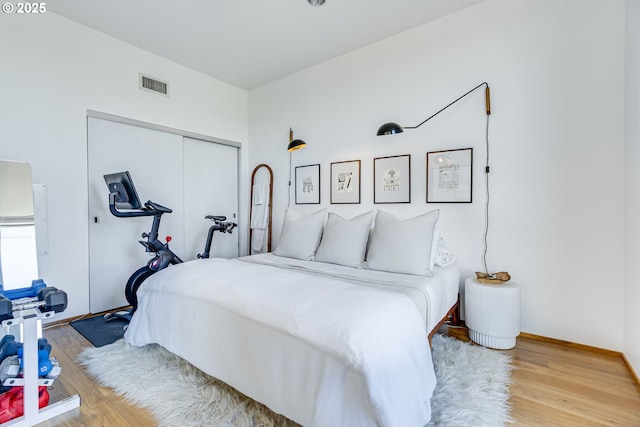 2530 SE 26th Ave Unit 401, Portland, OR 97202 - bedroom featuring a closet, wood finished floors, and baseboards