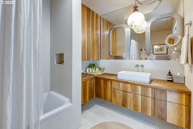 2530 SE 26th Ave Unit 401, Portland, OR 97202 - bathroom with tasteful backsplash, vanity, tiled shower / bath, and tile patterned floors