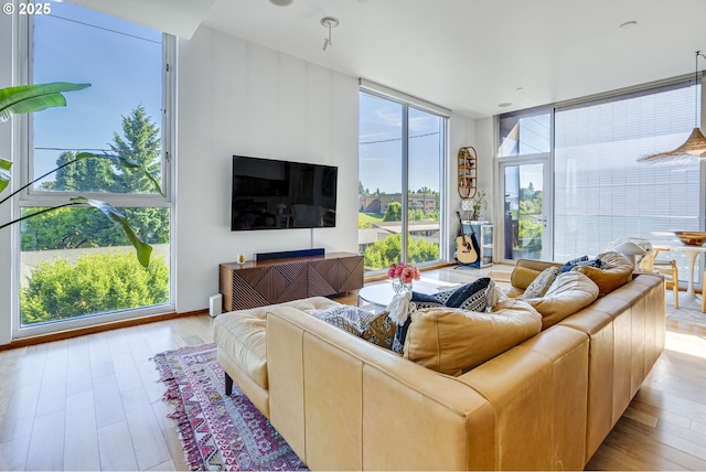 2530 SE 26th Ave Unit 401, Portland, OR 97202 - living room featuring expansive windows and wood finished floors