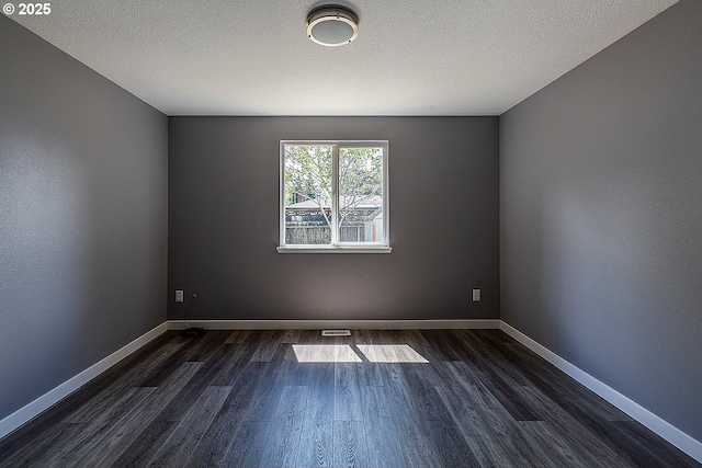 10522 SE Liebe St, Portland, OR 97266 - empty room with dark wood-style floors, baseboards, and a textured ceiling