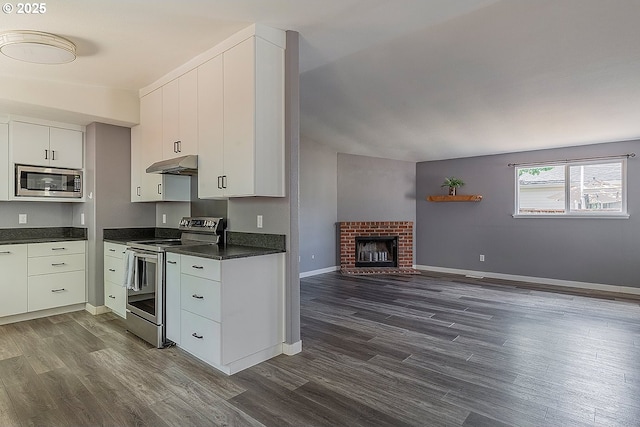 10522 SE Liebe St, Portland, OR 97266 - kitchen featuring stainless steel appliances, under cabinet range hood, dark countertops, and dark wood finished floors