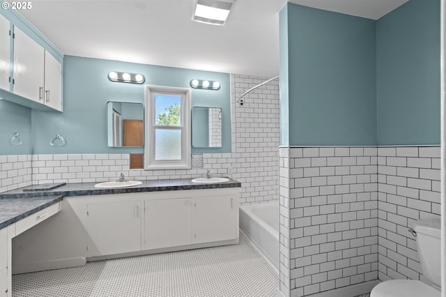 1001 NW Despain Ave, Pendleton, OR 97801 - full bath with double vanity, toilet, tile walls, tile patterned flooring, and tub / shower combination