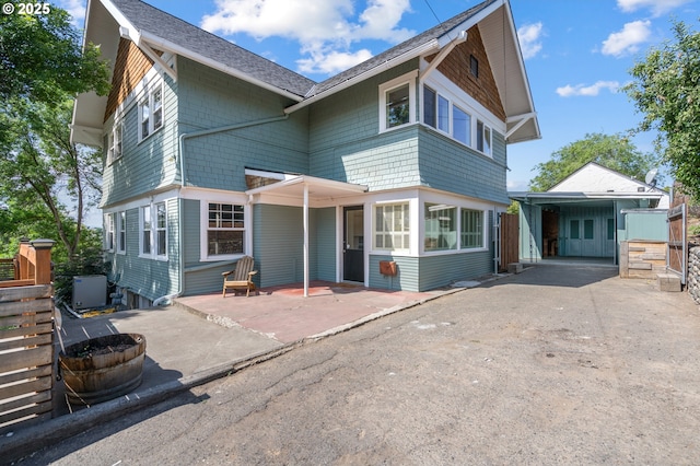 1001 NW Despain Ave, Pendleton, OR 97801 - view of front facade featuring a patio, a shingled roof, and asphalt driveway