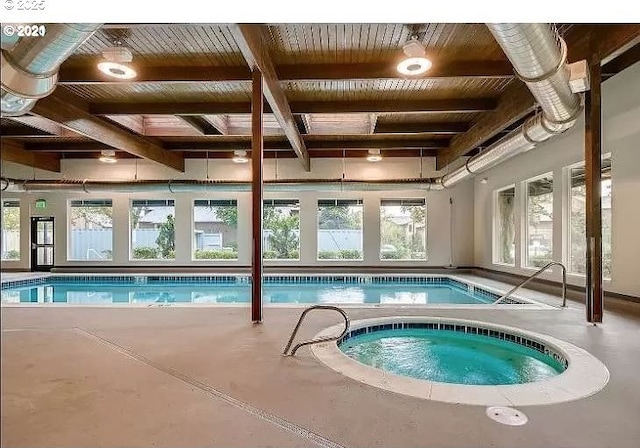 community pool with an indoor in ground hot tub