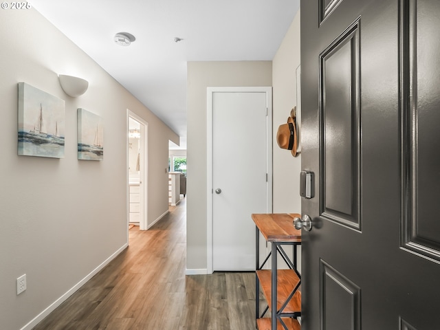 hall with dark wood finished floors and baseboards