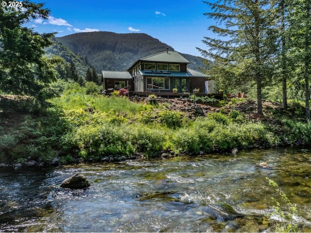 24940 E Tillicum St, Welches, OR 97067 - back of property with a mountain view, metal roof, and a view of trees