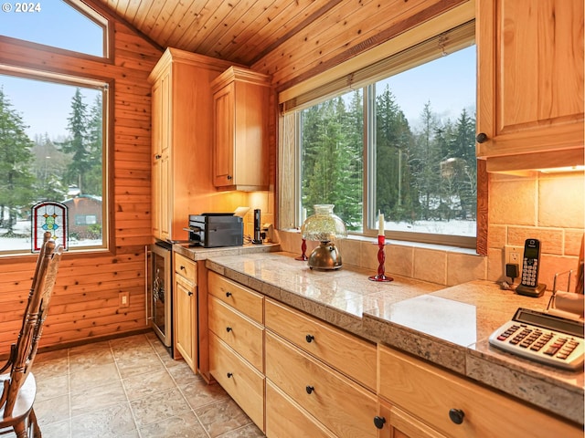 24940 E Tillicum St, Welches, OR 97067 - kitchen with tile countertops, wooden walls, healthy amount of natural light, wine cooler, and lofted ceiling